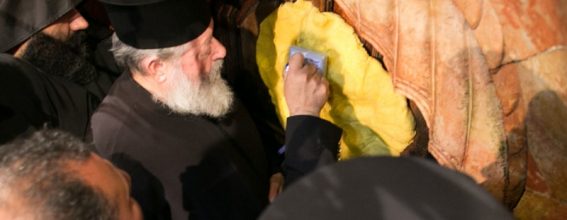The Elder Dragoman holding the wax for the Holy Seal