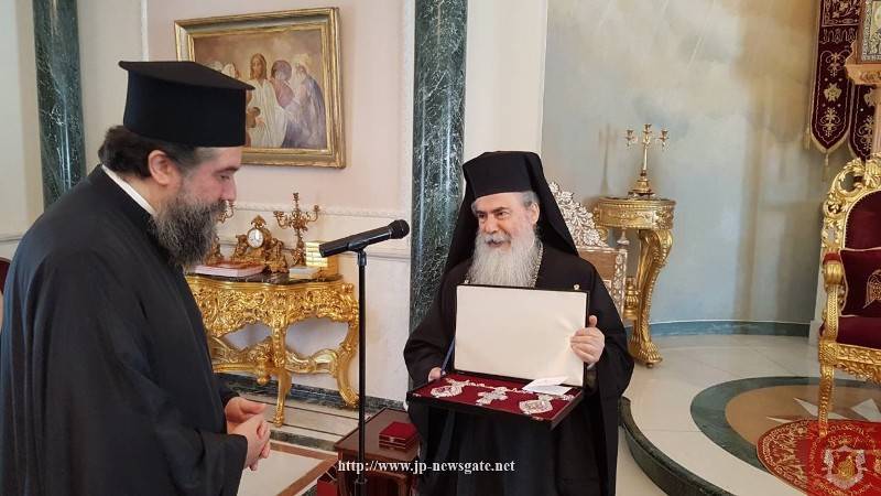 The Most Rev. Metropolitan of Serres, offering His Beatitude a set of egolpia